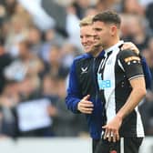 Newcastle United’s English head coach Eddie Howe celebrates with Bruno Guimaraes (Photo by LINDSEY PARNABY/AFP via Getty Images)