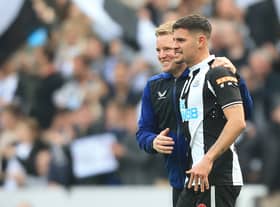 Newcastle United’s English head coach Eddie Howe celebrates with Bruno Guimaraes (Photo by LINDSEY PARNABY/AFP via Getty Images)