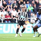 Kieran Trippier of Newcastle United crosses the ball which is adjudged to have hit the hand of Jefferson Lerma  (Photo by George Wood/Getty Images)