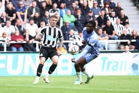 Kieran Trippier of Newcastle United crosses the ball which is adjudged to have hit the hand of Jefferson Lerma  (Photo by George Wood/Getty Images)