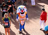 Members of the public finish during the 2021 Virgin Money London Marathon