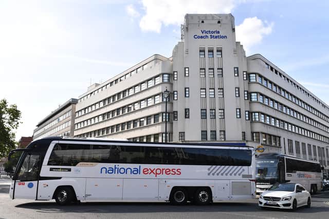 National Express coaches drive past Victoria bus station in London