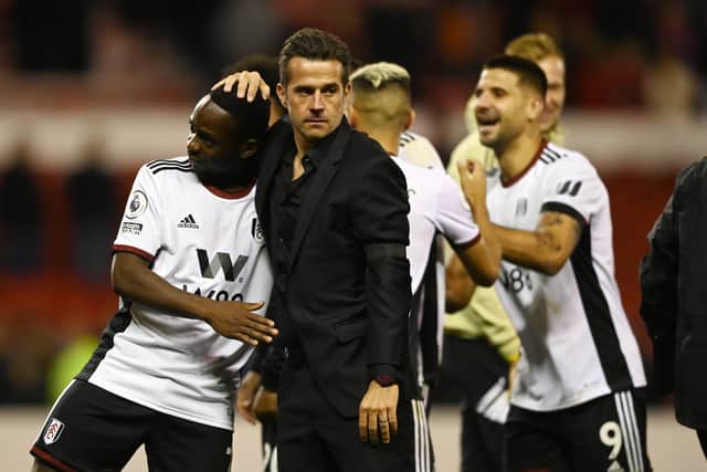eeskens Kebano of Fulham (L) and Marco Silva, Manager of Fulham celebrate following their side’s victory in the Premier League match against Nottingham Forest