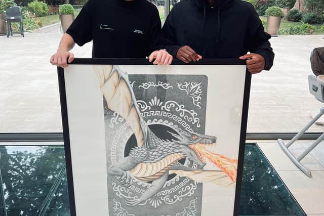 Ed Pettit with his artwork and Newcastle United star Allan Saint-Maximin