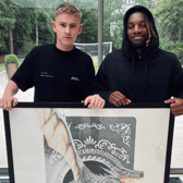 Ed Pettitt with his artwork and Newcastle United star Allan Saint-Maximin