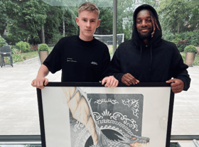 Ed Pettitt with his artwork and Newcastle United star Allan Saint-Maximin