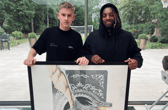 Ed Pettitt with his artwork and Newcastle United star Allan Saint-Maximin