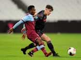 Amadou Diallo of West Ham United is tackled by Stoke City’s Thomas Sparrow  during the Premier League 2 match  on February 17, 2020 (Photo by Alex Burstow/Getty Images)