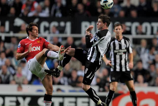 Danny Guthrie of Newcastle United competes with Michael Owen of Manchester United in April 2011 (Photo by Michael Regan/Getty Images)