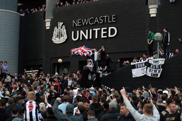 Newcastle United supporters celebrate outside the club’s stadium St James’ Park in Newcastle upon Tyne in northeast England on October 7, 2021, after the sale of the football club to a Saudi-led consortium was confirmed. - A Saudi-led consortium completed its takeover of Premier League club Newcastle United on October 7 despite warnings from Amnesty International that the deal represented “sportswashing” of the Gulf kingdom’s human rights record. (Photo by - / AFP) (Photo by -/AFP via Getty Images)
