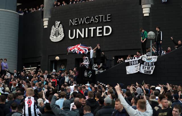 Newcastle United supporters celebrate outside the club’s stadium St James’ Park in Newcastle upon Tyne in northeast England on October 7, 2021, after the sale of the football club to a Saudi-led consortium was confirmed. - A Saudi-led consortium completed its takeover of Premier League club Newcastle United on October 7 despite warnings from Amnesty International that the deal represented “sportswashing” of the Gulf kingdom’s human rights record. (Photo by - / AFP) (Photo by -/AFP via Getty Images)