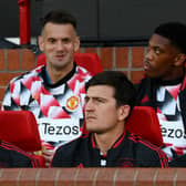 Harry Maguire and Luke Shaw of Manchester United look on from the substitutes bench prior to their side’s game with Liverpool (Photo by Michael Regan/Getty Images)