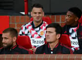 Harry Maguire and Luke Shaw of Manchester United look on from the substitutes bench prior to their side’s game with Liverpool (Photo by Michael Regan/Getty Images)