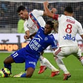 Bruno Guimaraes and Houssem Aouar fights for the ball during the game against Troyes in September 2021 (Photo by JEAN-PHILIPPE KSIAZEK / AFP)
