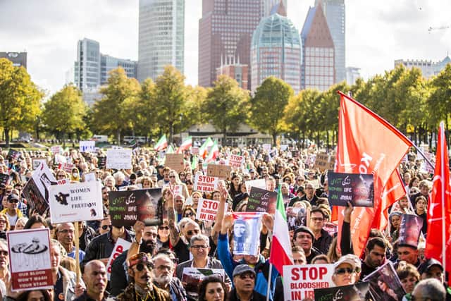 People take part in a rally on the Malieveld following the death of the Iranian Mahsa Amini in The Hague on October 8, 2022