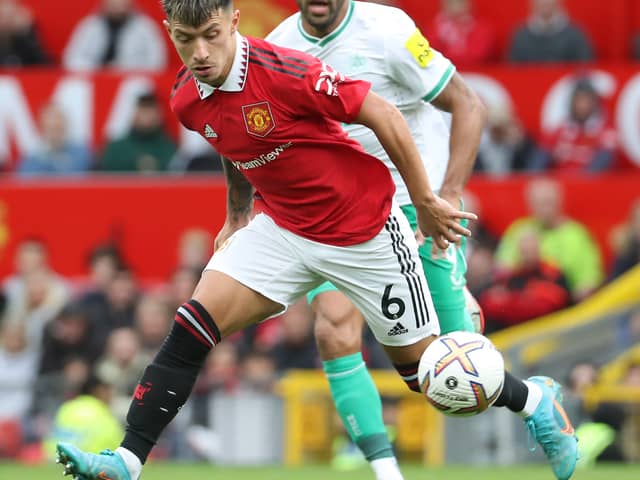 Lisandro Martinez of Manchester United in action with Callum Wilson of Newcastle United (Photo by Tom Purslow/Manchester United via Getty Images)