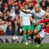 Bruno Guimaraes of Newcastle United is tackled by Casemiro of Manchester United during the Premier League match between Manchester United and Newcastle United at Old Trafford on October 16, 2022 in Manchester, England.