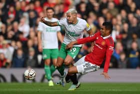 Bruno Guimaraes of Newcastle United is tackled by Casemiro of Manchester United during the Premier League match between Manchester United and Newcastle United at Old Trafford on October 16, 2022 in Manchester, England.