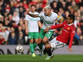 Bruno Guimaraes of Newcastle United is tackled by Casemiro of Manchester United during the Premier League match between Manchester United and Newcastle United at Old Trafford on October 16, 2022 in Manchester, England.
