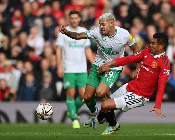 Bruno Guimaraes of Newcastle United is tackled by Casemiro of Manchester United during the Premier League match between Manchester United and Newcastle United at Old Trafford on October 16, 2022 in Manchester, England.