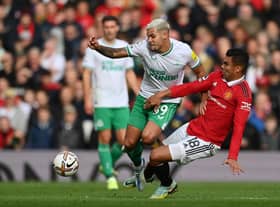 Bruno Guimaraes of Newcastle United is tackled by Casemiro of Manchester United during the Premier League match between Manchester United and Newcastle United at Old Trafford on October 16, 2022 in Manchester, England.