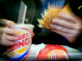  A man eats his lunch at a Burger King restaurant.