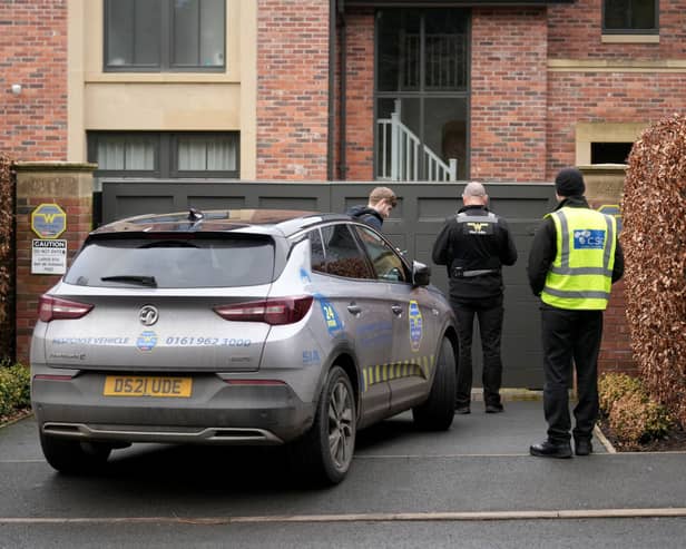Police officers standing outside Mason Greenwood’s house in February 2022.