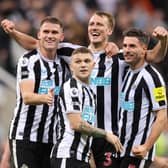 NEWCASTLE UPON TYNE, ENGLAND - OCTOBER 19: Sven Botman, Kieran Trippier, Dan Burn and Fabian Schar of Newcastle United celebrate their side's win after the final whistle of the Premier League match between Newcastle United and Everton FC at St. James Park on October 19, 2022 in Newcastle upon Tyne, England. (Photo by George Wood/Getty Images)
