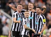 NEWCASTLE UPON TYNE, ENGLAND - OCTOBER 19: Sven Botman, Kieran Trippier, Dan Burn and Fabian Schar of Newcastle United celebrate their side's win after the final whistle of the Premier League match between Newcastle United and Everton FC at St. James Park on October 19, 2022 in Newcastle upon Tyne, England. (Photo by George Wood/Getty Images)