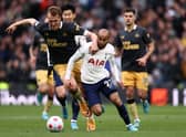 Lucas Moura is challenged by Dan Burn during the Premier League match between Tottenham Hotspur and Newcastle United (Photo by Ryan Pierse/Getty Images)