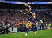 Callum Wilson celebrates with Miguel Almiron of Newcastle United after scoring their team’s first goal at Tottenham Hotspur (Photo by Justin Setterfield/Getty Images)