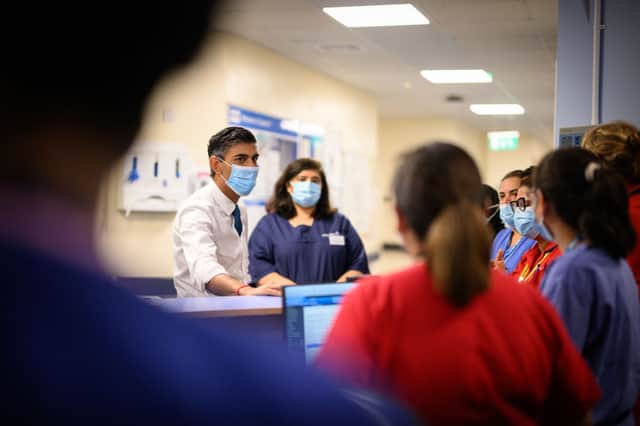 Prime Minister Rishi Sunak speaks with members of staff as he visits Croydon University hospital on October 28, 2022 in London, England. The Prime Minister is reported to be reviewing proposals for next monthâs autumn statement, in a bid to raise up to Â£50 billion a year through a combination of spending cuts and tax rises. 