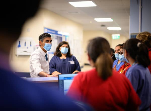 Prime Minister Rishi Sunak speaks with members of staff as he visits Croydon University hospital on October 28, 2022 in London, England. The Prime Minister is reported to be reviewing proposals for next monthâs autumn statement, in a bid to raise up to Â£50 billion a year through a combination of spending cuts and tax rises. 