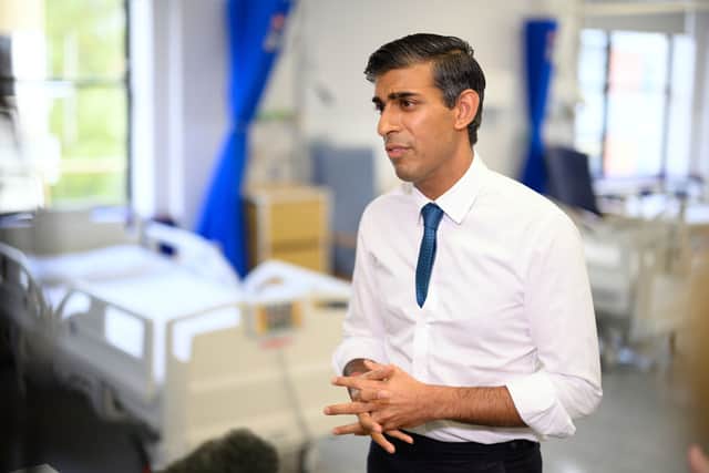 Prime Minister Rishi Sunak speaks with members of the media as he visits Croydon University hospital on October 28, 2022 in London, England. The Prime Minister is reported to be reviewing proposals for next monthâs autumn statement, in a bid to raise up to Â£50 billion a year through a combination of spending cuts and tax rises. 