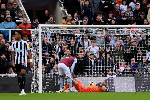 Aston Villa goalkeeper Emi Martinez goes down injured against Newcastle United. (Photo by Stu Forster/Getty Images)