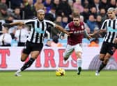 Emi Buendia of Aston Villa is challenged by Newcastle United’s Brazilian duo Joelinton and Bruno Guimaraes  (Photo by Nigel Roddis/Getty Images)