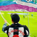 Ian with a Newcastle United Pride flag before the meeting with Villa (Image: United with Pride)