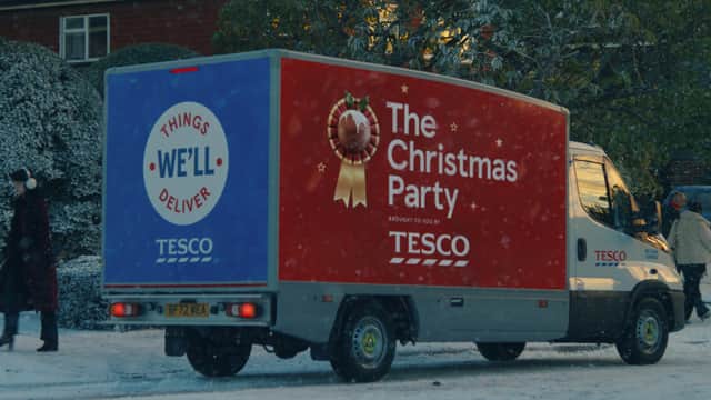 A Tesco Delivery Van, with the words ‘The Christmas Party’ and a mince pie in a ribbon emblazoned on the side (Credit: Tesco)
