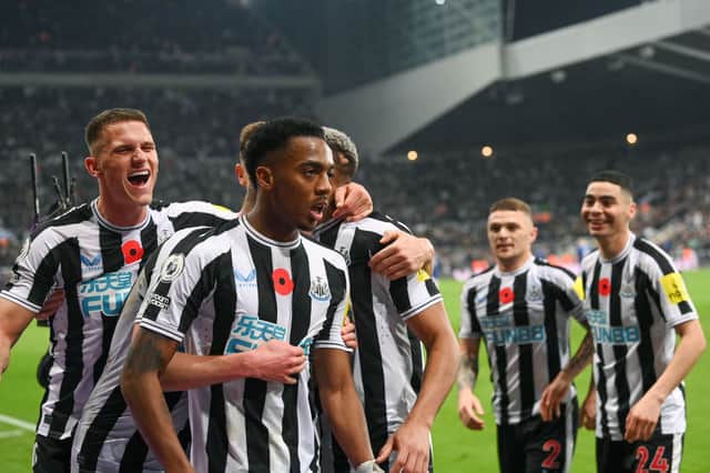Joe Willock of Newcastle United celebrates after scoring their team’s first goal during the Premier League match between Newcastle United and Chelsea FC at St. James Park on November 12, 2022 in Newcastle upon Tyne, England.
