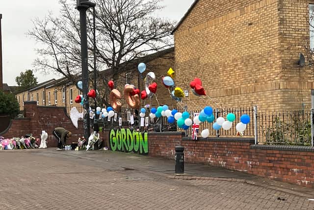 Flowers and balloons are laid as a tribute to the teenager in Elswick