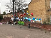 Flowers and balloons are laid as a tribute to the teenager in Elswick