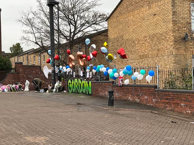 Flowers and balloons are laid as a tribute to the teenager in Elswick