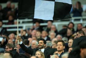 Mehrdad Ghodoussi, husband of Newcastle United’s English minority owner Amanda Staveley waves a flag in the crowd ahead of the English Premier League football match between Newcastle United and Wolverhampton Wanderers at St James’ Park in Newcastle-upon-Tyne, north east England on April 8, 2022. - RESTRICTED TO EDITORIAL USE. No use with unauthorized audio, video, data, fixture lists, club/league logos or ‘live’ services. Online in-match use limited to 120 images. An additional 40 images may be used in extra time. No video emulation. Social media in-match use limited to 120 images. An additional 40 images may be used in extra time. No use in betting publications, games or single club/league/player publications. (Photo by Lindsey Parnaby / AFP) / RESTRICTED TO EDITORIAL USE. No use with unauthorized audio, video, data, fixture lists, club/league logos or ‘live’ services. Online in-match use limited to 120 images. An additional 40 images may be used in extra time. No video emulation. Social media in-match use limited to 120 images. An additional 40 images may be used in extra time. No use in betting publications, games or single club/league/player publications. / RESTRICTED TO EDITORIAL USE. No use with unauthorized audio, video, data, fixture lists, club/league logos or ‘live’ services. Online in-match use limited to 120 images. An additional 40 images may be used in extra time. No video emulation. Social media in-match use limited to 120 images. An additional 40 images may be used in extra time. No use in betting publications, games or single club/league/player publications. (Photo by LINDSEY PARNABY/AFP via Getty Images)