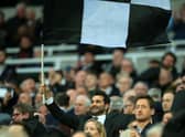 Mehrdad Ghodoussi, husband of Newcastle United’s English minority owner Amanda Staveley waves a flag in the crowd ahead of the English Premier League football match between Newcastle United and Wolverhampton Wanderers at St James’ Park in Newcastle-upon-Tyne, north east England on April 8, 2022. - RESTRICTED TO EDITORIAL USE. No use with unauthorized audio, video, data, fixture lists, club/league logos or ‘live’ services. Online in-match use limited to 120 images. An additional 40 images may be used in extra time. No video emulation. Social media in-match use limited to 120 images. An additional 40 images may be used in extra time. No use in betting publications, games or single club/league/player publications. (Photo by Lindsey Parnaby / AFP) / RESTRICTED TO EDITORIAL USE. No use with unauthorized audio, video, data, fixture lists, club/league logos or ‘live’ services. Online in-match use limited to 120 images. An additional 40 images may be used in extra time. No video emulation. Social media in-match use limited to 120 images. An additional 40 images may be used in extra time. No use in betting publications, games or single club/league/player publications. / RESTRICTED TO EDITORIAL USE. No use with unauthorized audio, video, data, fixture lists, club/league logos or ‘live’ services. Online in-match use limited to 120 images. An additional 40 images may be used in extra time. No video emulation. Social media in-match use limited to 120 images. An additional 40 images may be used in extra time. No use in betting publications, games or single club/league/player publications. (Photo by LINDSEY PARNABY/AFP via Getty Images)