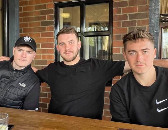 Truman (left) with brothers Hylton (middle) and Myles (right)