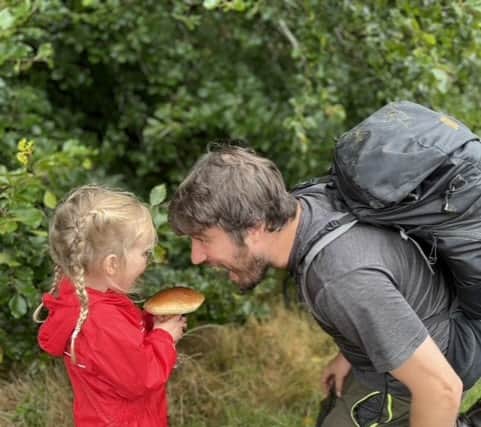 Jim Parums and his daugher foraging a mushroom - the family save £100 a week by foraging for all their meals.