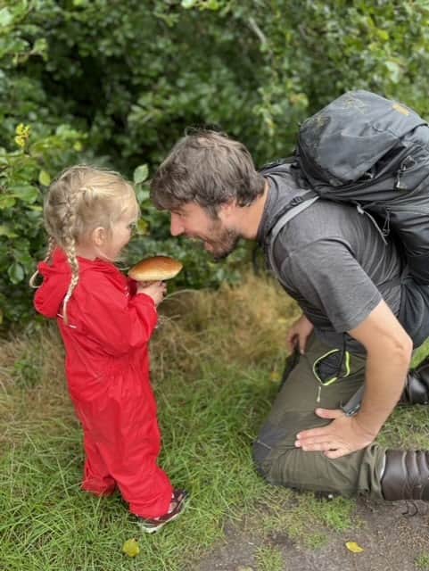 Jim Parums and his daugher foraging a mushroom - the family save £100 a week by foraging for all their meals. 