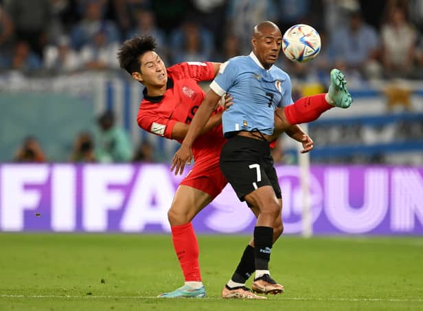 <p>Kangin Lee of Korea Republic battles for possession with Nicolas De La Cruz of Uruguay during the World Cup Group H match (Photo by Clive Mason/Getty Images)</p>