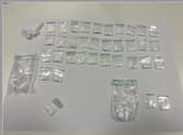 The haul of drug wraps found in the vehicle.