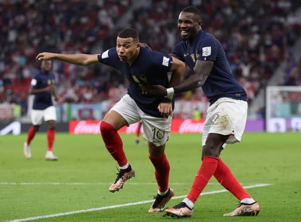 Marcus Thuram (right) celebrates with France teammate Kylian Mbappe (left) at the FIFA World Cup in Qatar.
